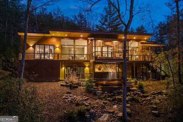 rear view of property featuring a deck