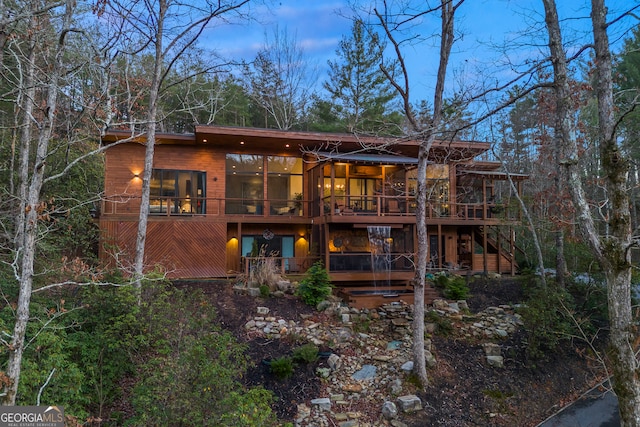 back of house with a wooden deck