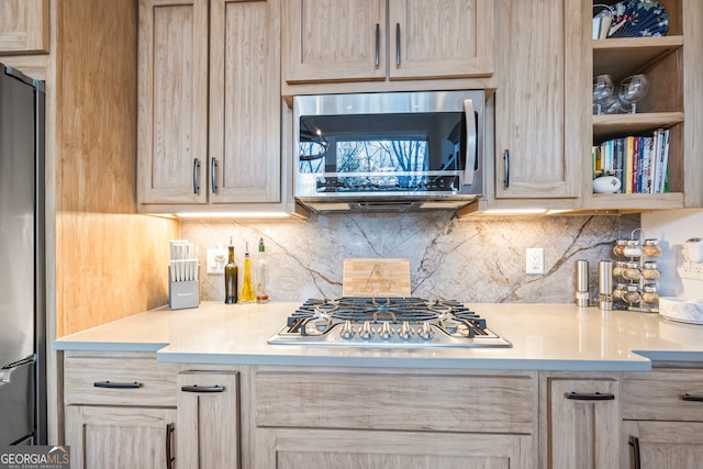 kitchen featuring stainless steel appliances, tasteful backsplash, and light brown cabinetry