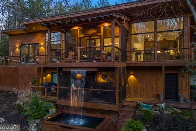 back house at night with a sunroom