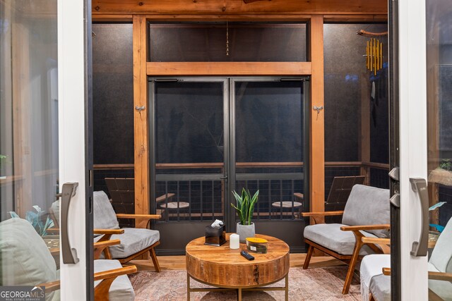 living room featuring floor to ceiling windows, tile patterned floors, a chandelier, and a skylight