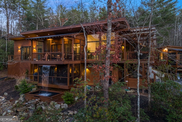 rear view of property featuring a sunroom