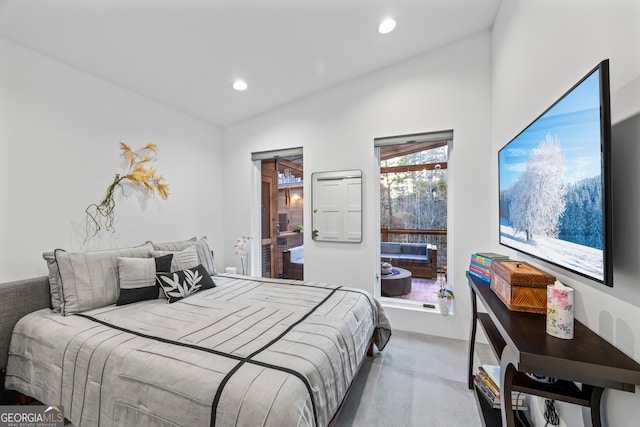 bedroom with concrete flooring and vaulted ceiling