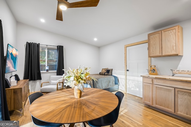 dining room featuring vaulted ceiling, ceiling fan, and light wood-type flooring