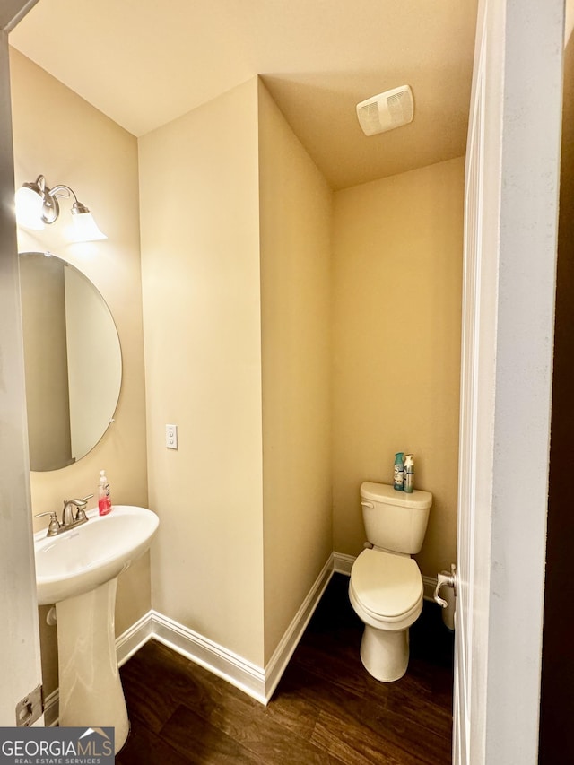 bathroom featuring toilet and hardwood / wood-style flooring