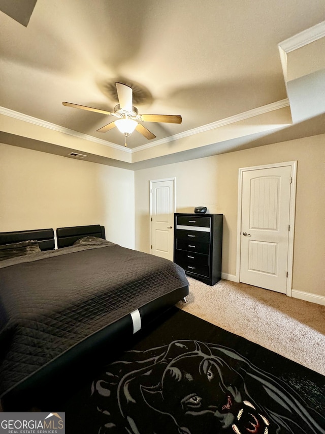 bedroom featuring carpet flooring, a raised ceiling, ceiling fan, and ornamental molding