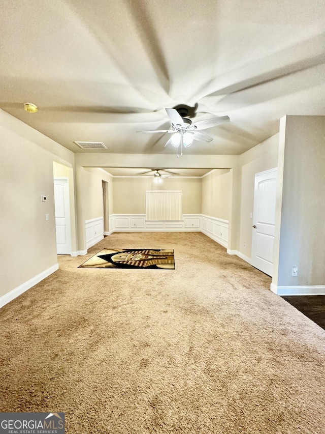 unfurnished living room with carpet flooring and ceiling fan