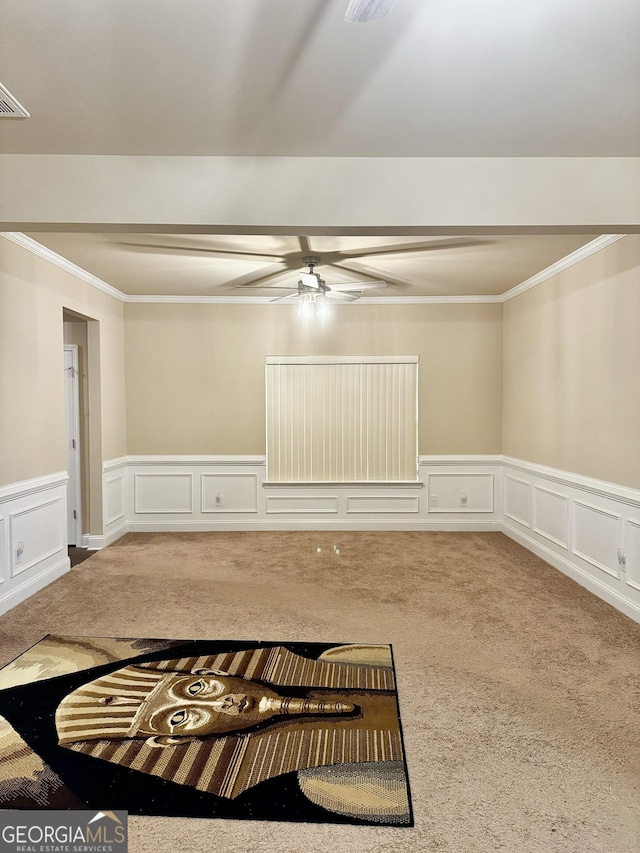 unfurnished room with carpet flooring, ceiling fan, and crown molding