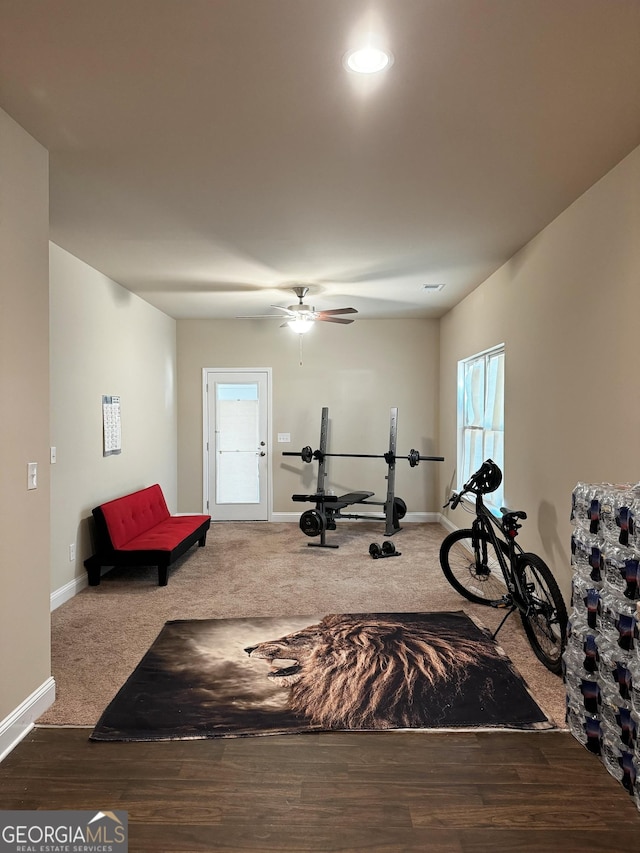 exercise area with ceiling fan and carpet