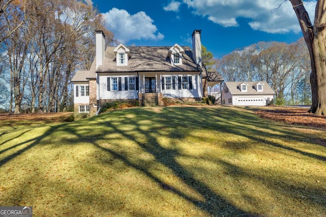 cape cod-style house with a front yard