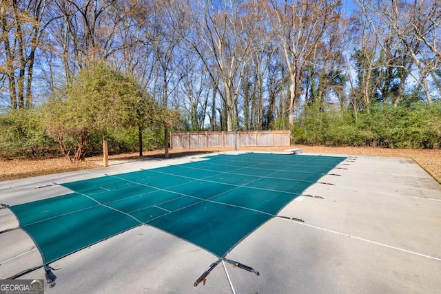 view of pool with a diving board