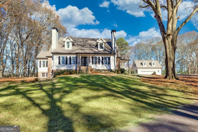 cape cod house featuring a garage and a front yard