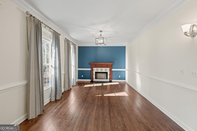 unfurnished living room featuring dark hardwood / wood-style floors, crown molding, and a fireplace