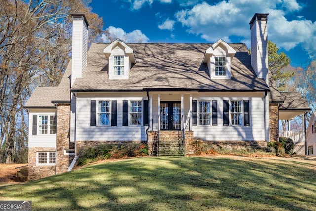 new england style home with a front yard and french doors