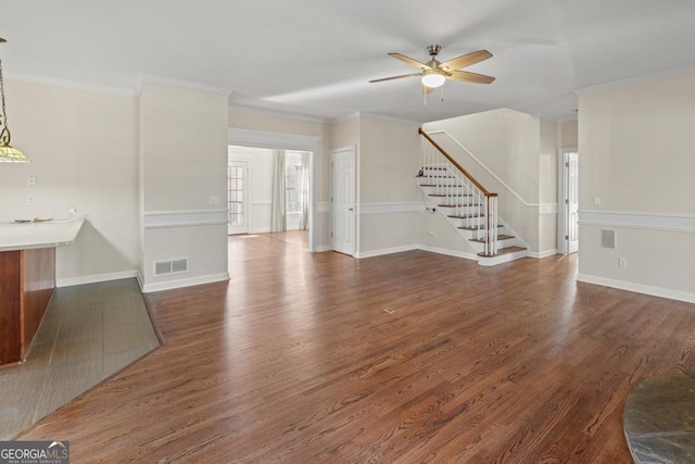 unfurnished living room featuring ceiling fan, crown molding, and dark hardwood / wood-style floors