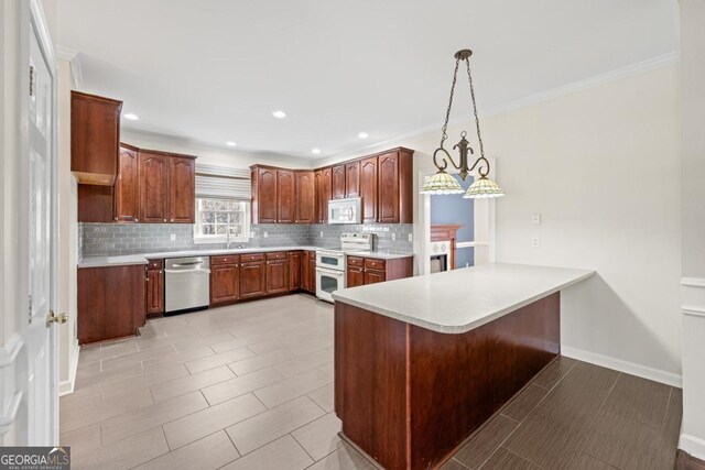 kitchen with kitchen peninsula, backsplash, white appliances, sink, and hanging light fixtures