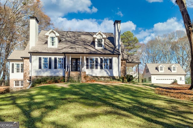 cape cod house featuring a front yard