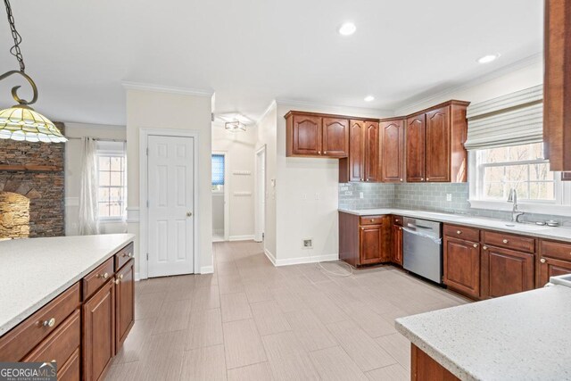 kitchen featuring backsplash, stainless steel dishwasher, ornamental molding, sink, and hanging light fixtures