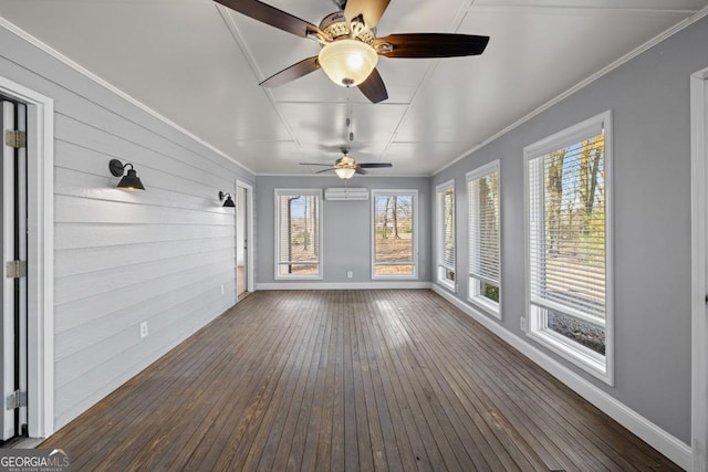 unfurnished sunroom featuring plenty of natural light and an AC wall unit