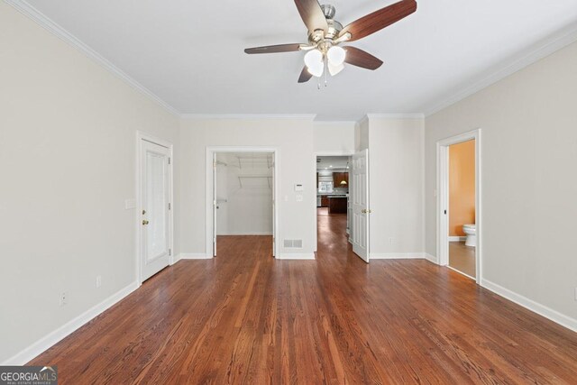 interior space featuring crown molding, dark hardwood / wood-style flooring, and ceiling fan