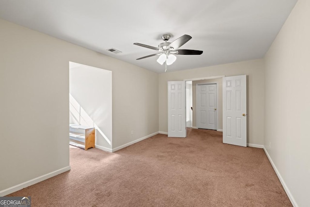 unfurnished bedroom with ceiling fan and light colored carpet