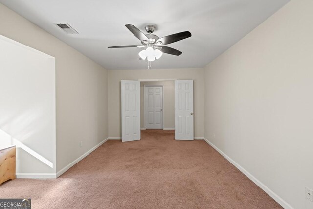 unfurnished bedroom featuring light colored carpet and ceiling fan