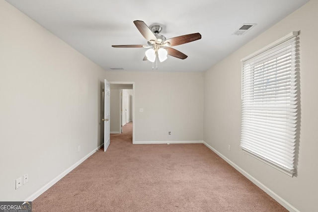 unfurnished bedroom featuring light colored carpet and ceiling fan