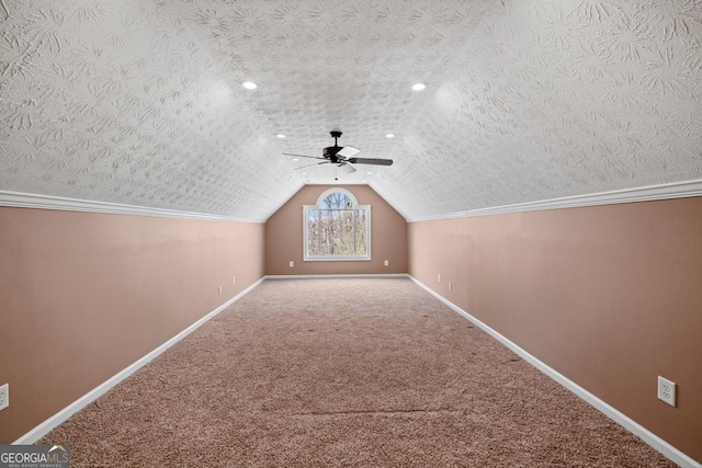 bonus room featuring ceiling fan, carpet floors, a textured ceiling, and lofted ceiling