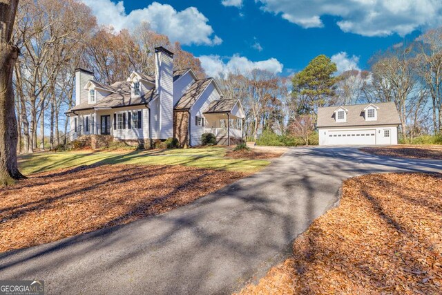 view of front of property with a garage and a front lawn