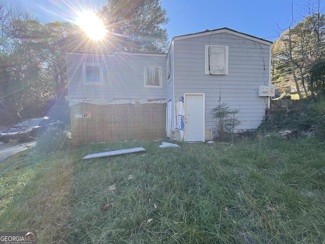 rear view of property featuring a yard