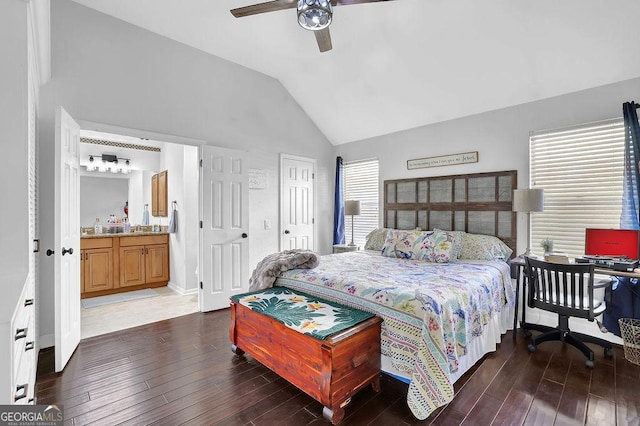 bedroom with ceiling fan, dark hardwood / wood-style flooring, ensuite bathroom, and vaulted ceiling