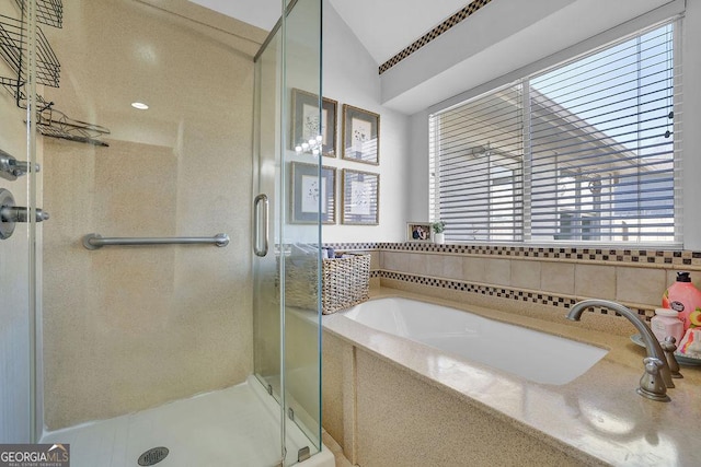 bathroom with separate shower and tub and vaulted ceiling