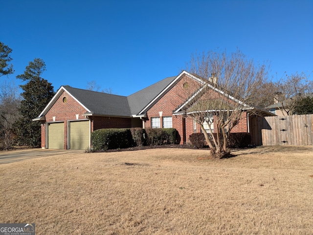 view of front of property with a garage and a front lawn