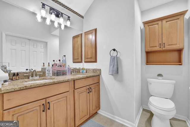 bathroom with tile patterned floors, vanity, and toilet