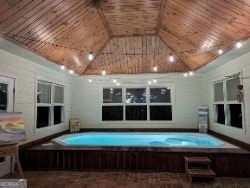 view of swimming pool with a jacuzzi