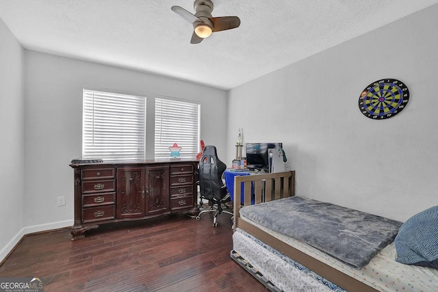 bedroom with ceiling fan and dark hardwood / wood-style floors