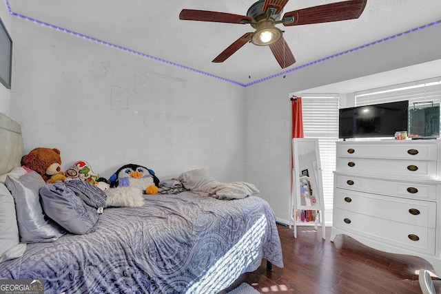 bedroom with ceiling fan and dark wood-type flooring