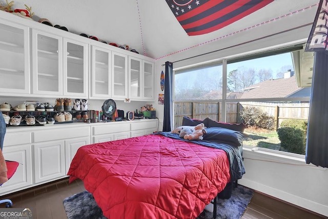 bedroom with dark hardwood / wood-style floors and vaulted ceiling