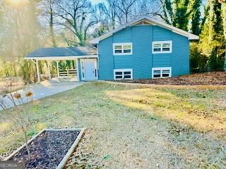 view of side of home with driveway and a carport