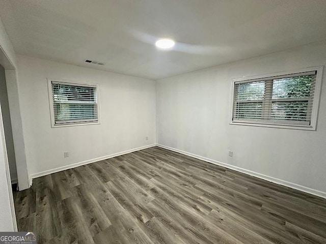 unfurnished room featuring dark wood-type flooring