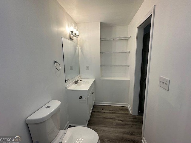 bathroom with hardwood / wood-style floors, vanity, and toilet