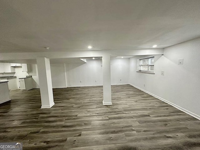 basement featuring dark hardwood / wood-style flooring