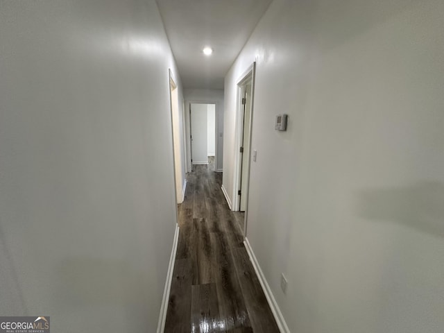 hallway with baseboards and dark wood finished floors