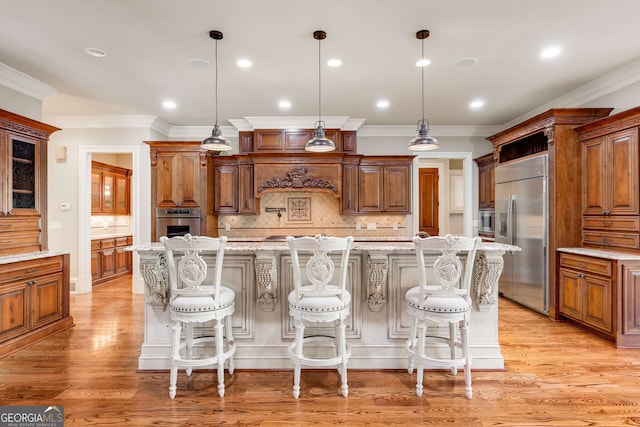 kitchen featuring a breakfast bar area, decorative backsplash, and appliances with stainless steel finishes