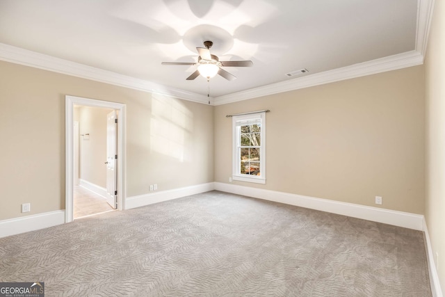 spare room with light colored carpet, ceiling fan, and crown molding