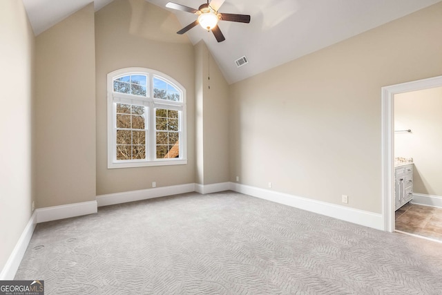 carpeted empty room featuring high vaulted ceiling and ceiling fan