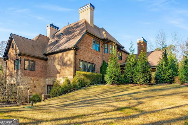 rear view of house featuring a yard