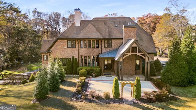 rear view of property with a porch and a yard