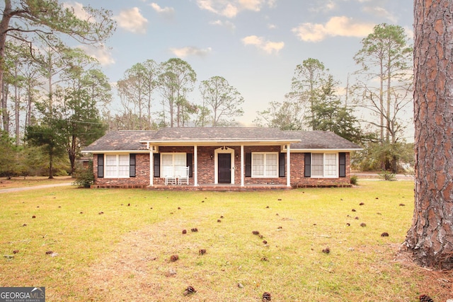 ranch-style home featuring a front yard and a porch