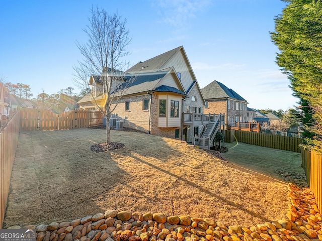 back of house with central AC and a deck